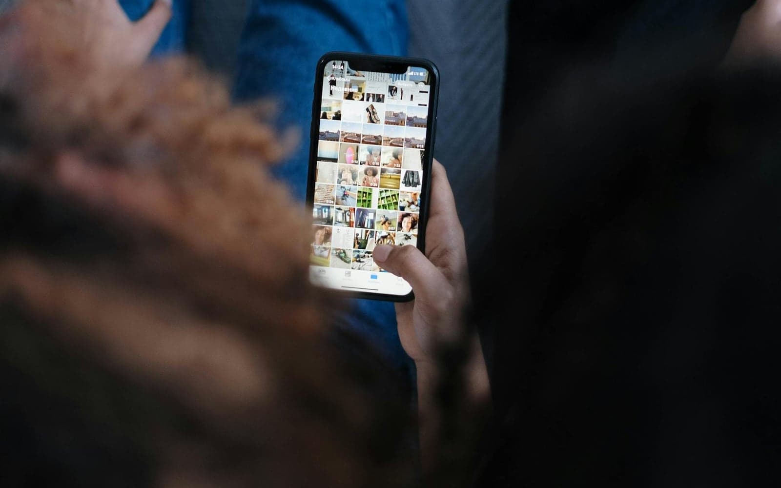 A person browsing a phone photo gallery before sharing